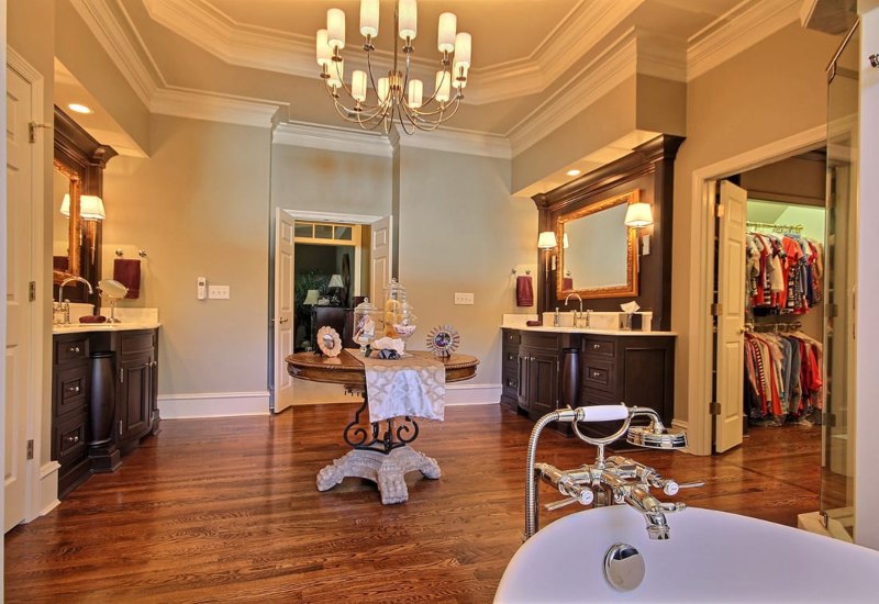 Stylish bathroom with dark‑wood vanity, gold‑trimmed mirror, soft lighting in Atlanta, GA