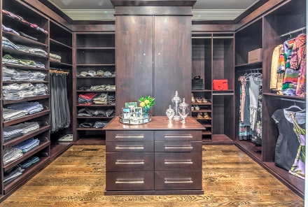 Master bathroom connected to a walk‑in closet with neatly organized clothing in Atlanta, GA